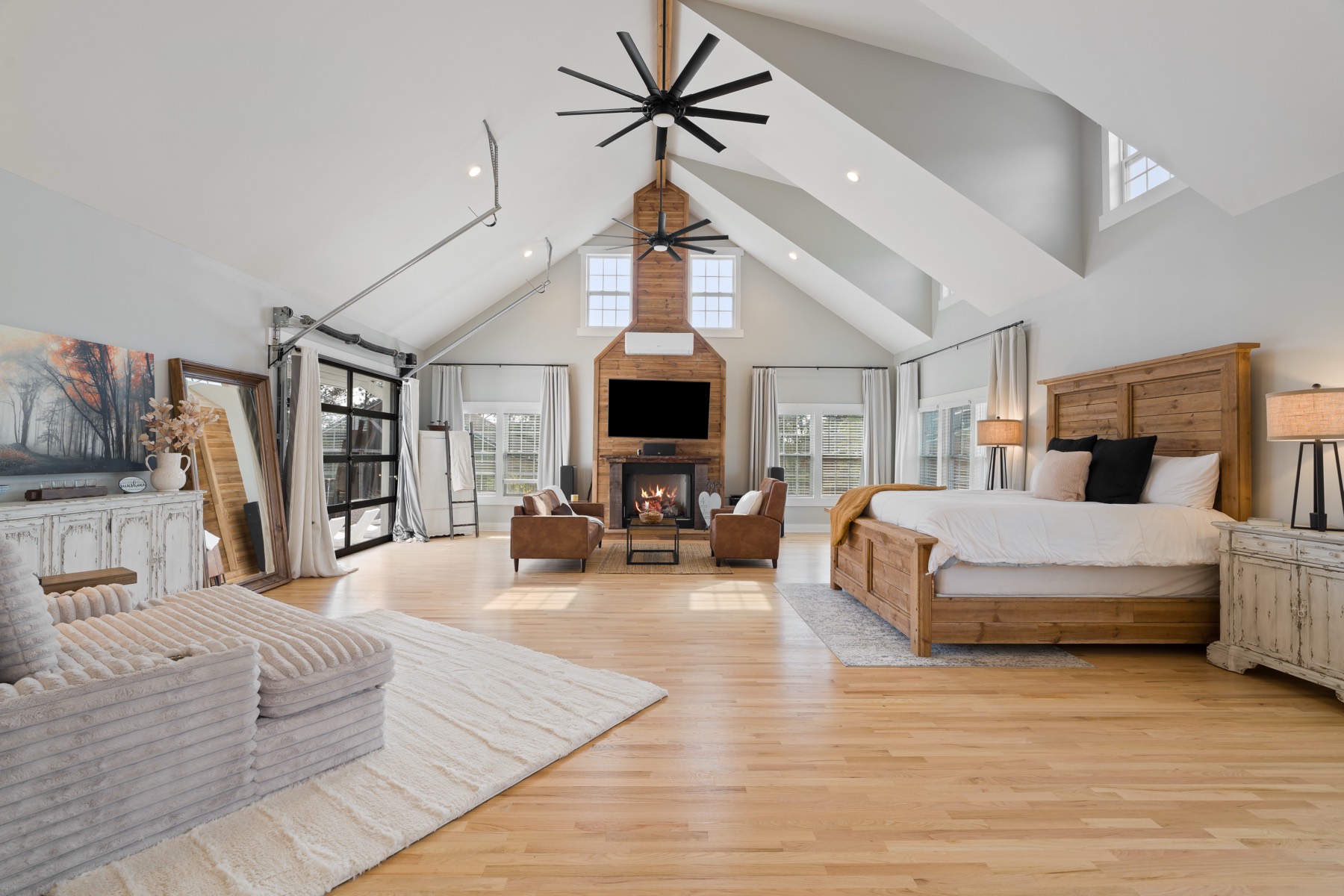 Vaulted primary suite with fireplace and sitting area