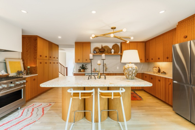 Retro-inspired kitchen with terrazzo island and warm wood cabinetry
